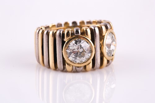 Lot 123 - A dual diamond dress ring, with two rub-over...