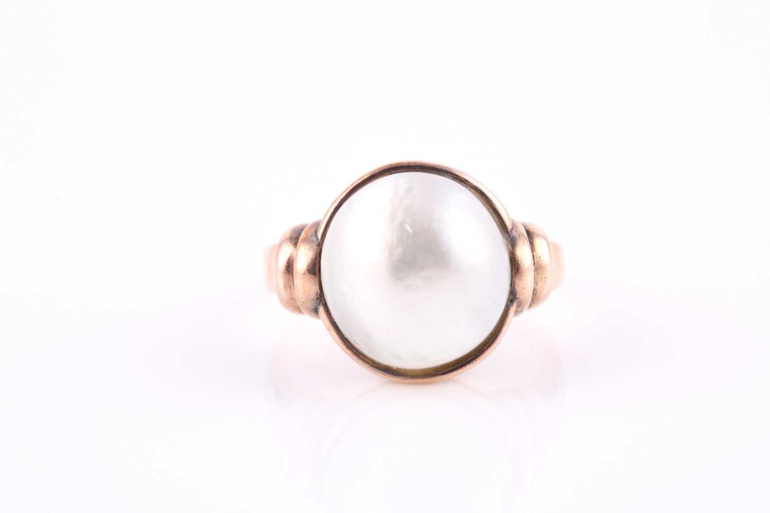Lot 156 - A mabe pearl ring, the off-round 11.5-12mm...
