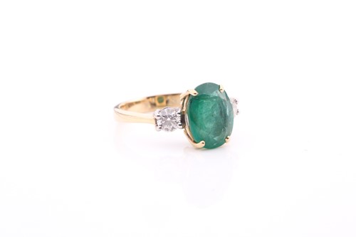 Lot 212 - A large emerald and diamond three stone ring...