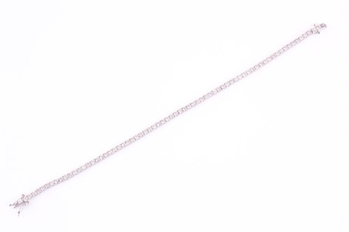 Lot 427 - A diamond line 'tennis' bracelet consisting of...