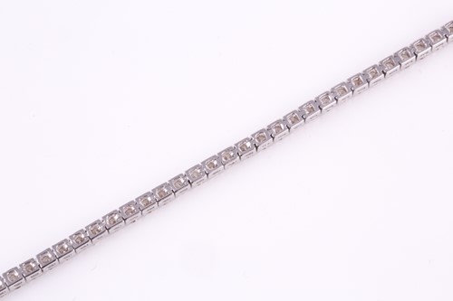 Lot 427 - A diamond line 'tennis' bracelet consisting of...