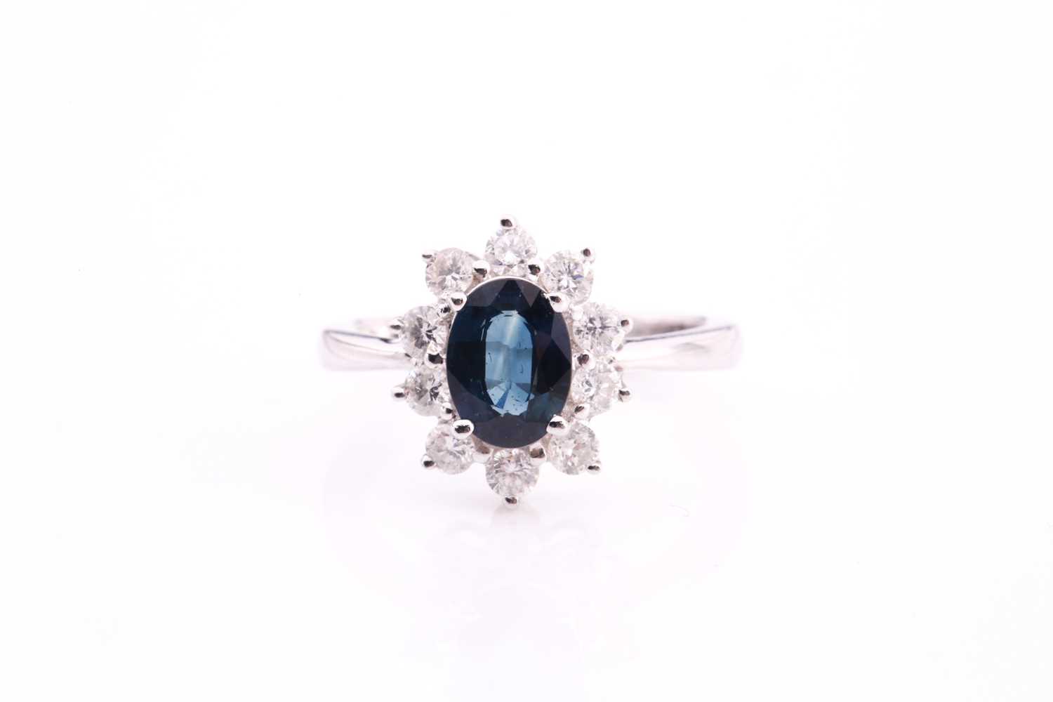 Lot 34 - A sapphire and diamond cluster ring, set with...