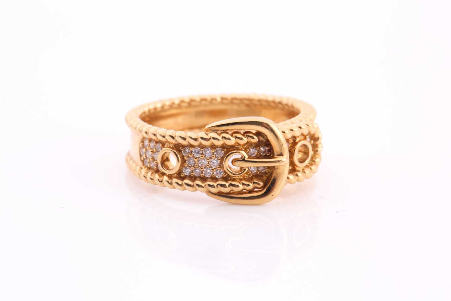 Lot 175 - A diamond-set buckle ring in yellow metal,...
