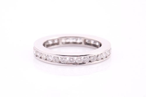 Lot 87 - A full eternity diamond set ring, channel set...