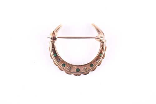 Lot 248 - An emerald and diamond crescent brooch,...