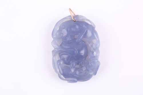Lot 129 - A Chinese chalcedony carved pendant, of oval...