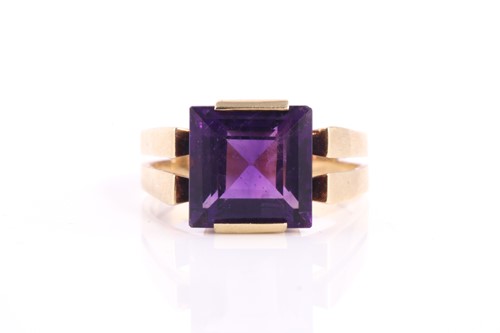 Lot 291 - A square amethyst dress ring, set with a...