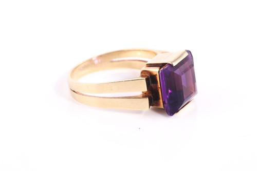 Lot 291 - A square amethyst dress ring, set with a...