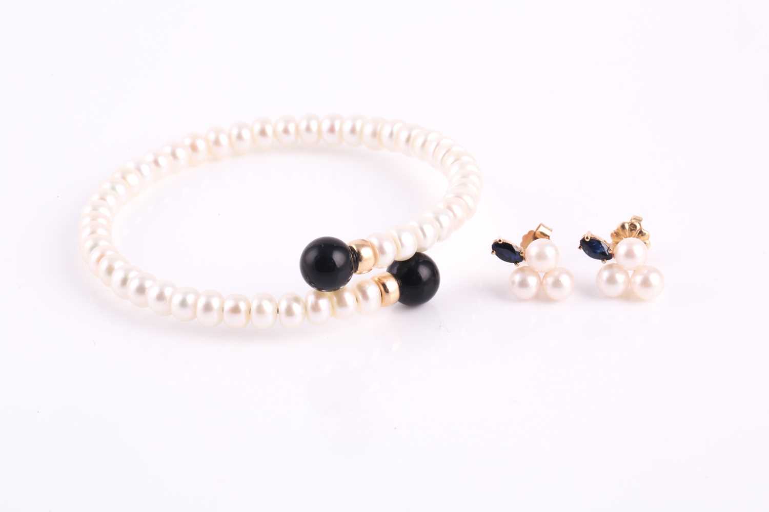 Lot 64 - A cultured pearl spring bracelet with gold...