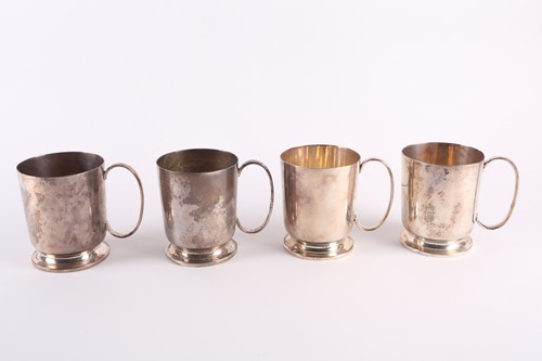 Lot 306 - A set of four white metal tankards each with a...