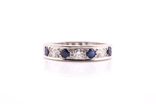 Lot 332 - A sapphire and diamond half hoop eternity ring;...