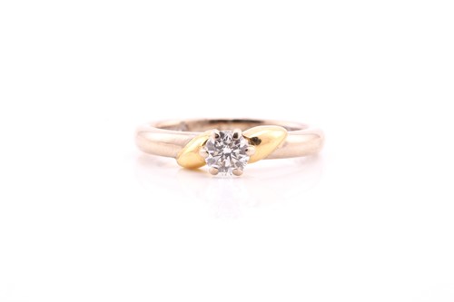 Lot 518 - A single stone diamond ring; the round...