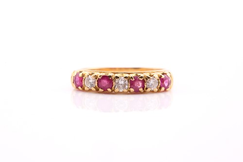 Lot 538 - A ruby and diamond seven stone half hoop ring;...