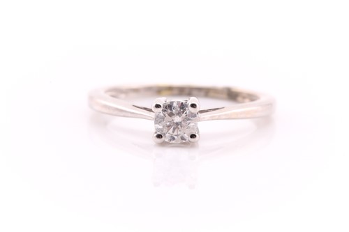 Lot 851 - A single stone diamond ring; the round...