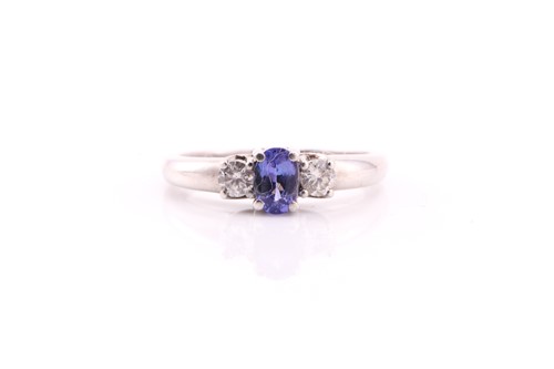 Lot 239 - A tanzanite and diamond three stone half hoop...