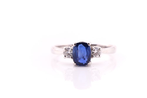 Lot 847 - A sapphire and diamond three stone half hoop...