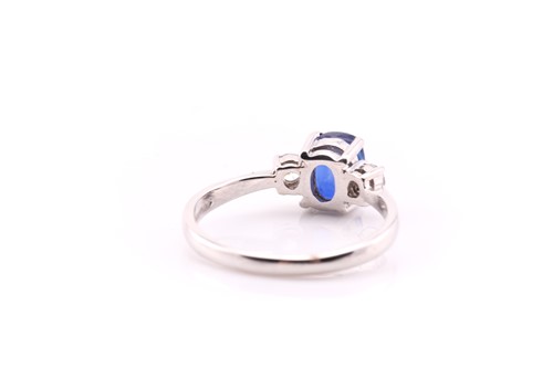 Lot 847 - A sapphire and diamond three stone half hoop...