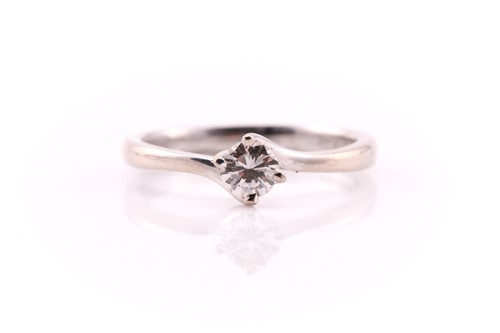 Lot 654 - A single stone diamond ring; the round...