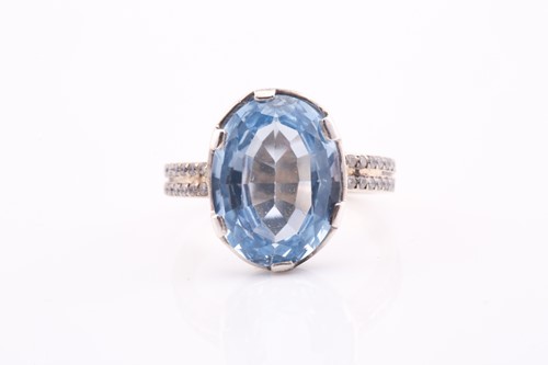 Lot 261 - A blue topaz and diamond ring, the oval mixed...