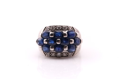 Lot 642 - A sapphire and diamond dress ring, composed of...