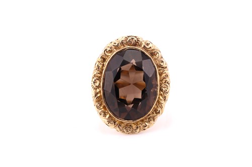 Lot 650 - A single stone smoky quartz cocktail ring; the...