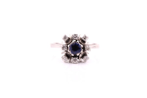 Lot 770 - A sapphire and diamond cluster ring; the...