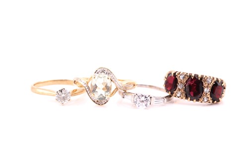 Lot 807 - A three stone half hop garnet ring, in 9 carat...