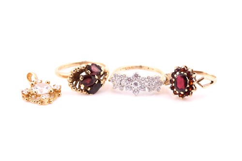 Lot 636 - A garnet cluster ring; a three stone garnet...