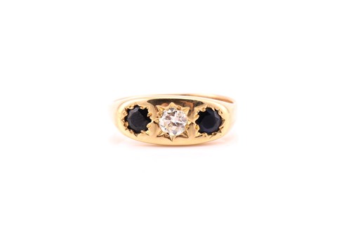 Lot 842 - A three stone sapphire and diamond gypsy set...