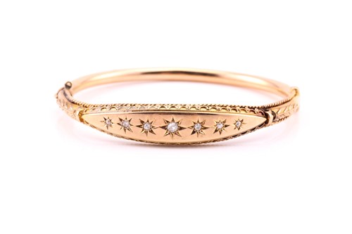 Lot 832 - A Victorian half hoop diamond set bangle; in...