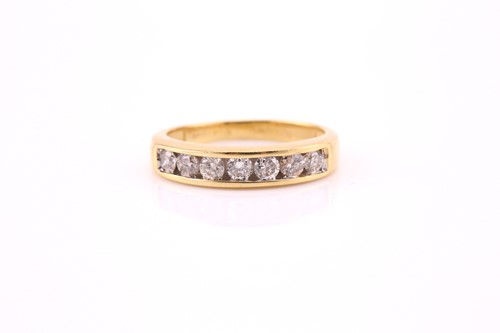 Lot 809 - A diamond seven stone, half hoop eternity ring,...