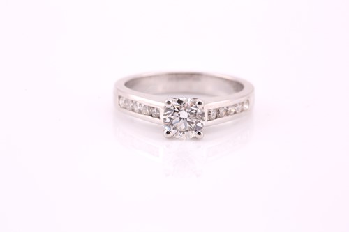 Lot 66 - A single stone diamond ring; the round...