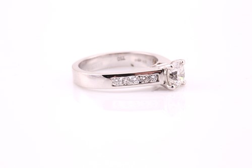 Lot 66 - A single stone diamond ring; the round...
