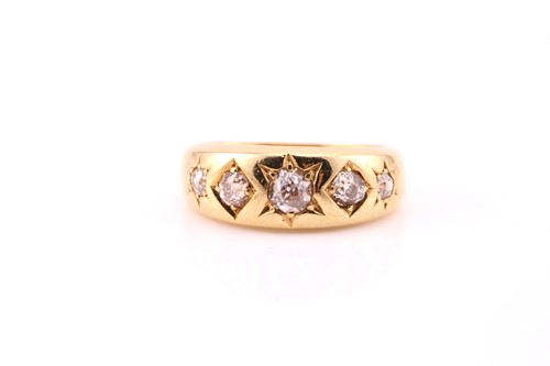 Lot 783 - A five stone gypsy set diamond ring; the...