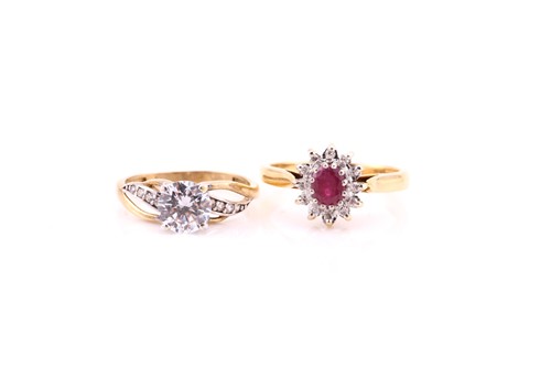 Lot 780 - A ruby and diamond oval cluster ring, in 18...