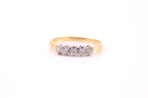 Lot 513 - A five stone diamond half hoop ring; the round...