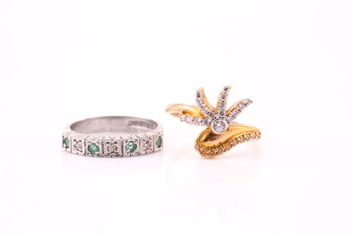 Lot 741 - A diamond and emerald ring half hoop eternity...