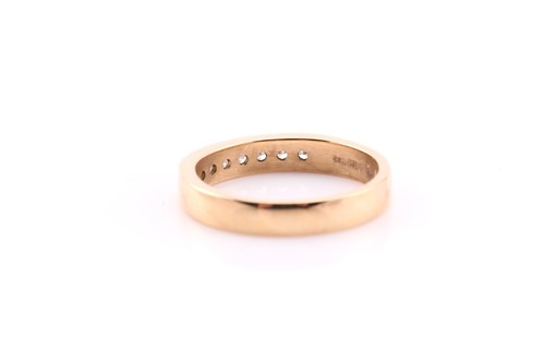 Lot 555 - A seven stone half hoop diamond eternity ring;...