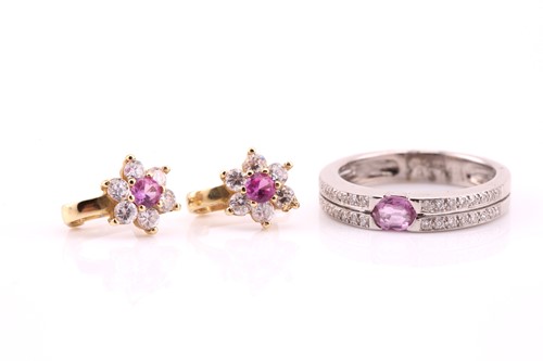 Lot 517 - A pink sapphire and diamond ring; the two row,...