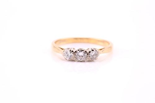 Lot 510 - A three stone half hoop diamond ring; the...