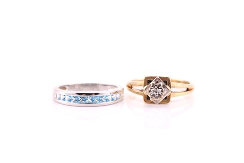 Lot 604 - A half hoop,princess cut blue topaz ring;...