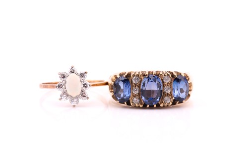 Lot 754 - A three stone half hoop oval sapphire ring;...