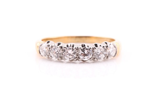 Lot 663 - A six stone diamond half hoop ring; the round...