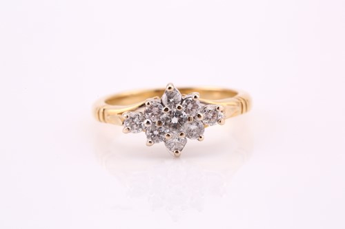 Lot 821 - A nine stone diamond cluster ring; the tiered,...