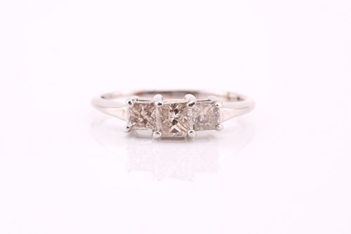 Lot 182 - A three stone half hoop diamond ring, the...