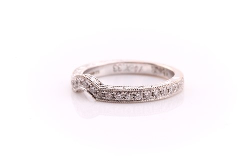 Lot 680 - A shaped, diamond half hoop wedding band; the...