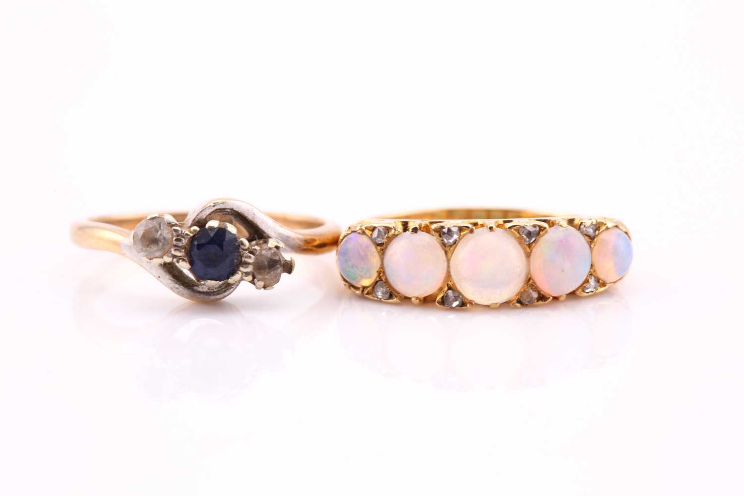 Lot 681 - A five stone half hoop ring; the slightly...
