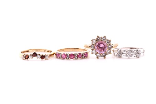 Lot 539 - A ruby five stone half hoop ring; in 9 carat...