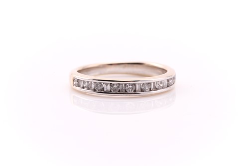 Lot 605 - A diamond half hoop eternity ring; alternately...