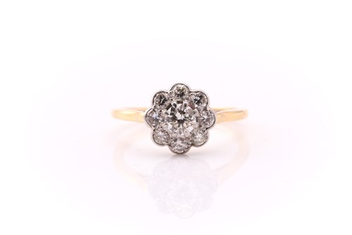 Lot 739 - A diamond cluster ring; the central round...